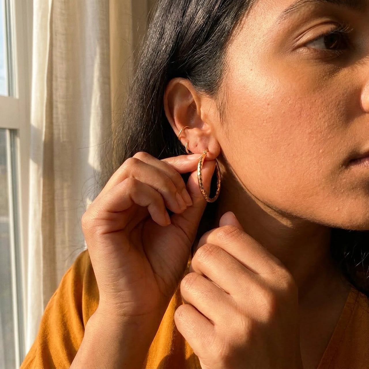 Diamond Cut Statement Hoops in Gold, being put on | SKU: 41009-gold