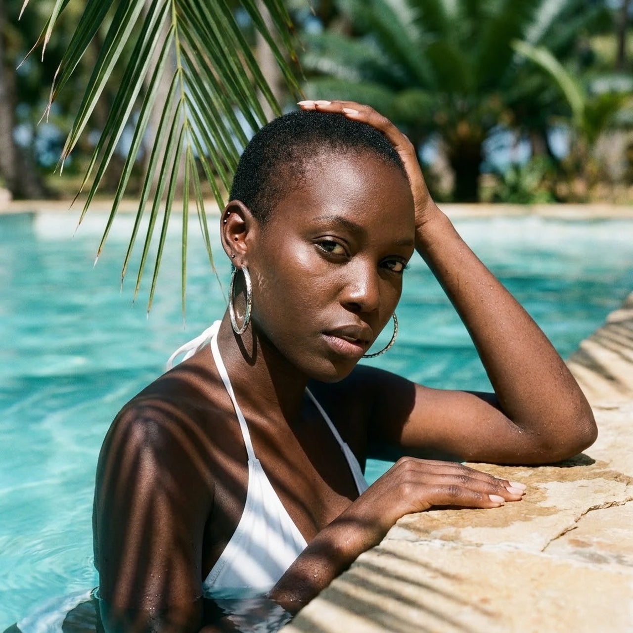 Diamond Cut Statement Hoops in Silver, worn by a tropical pool | SKU: 41009-silver