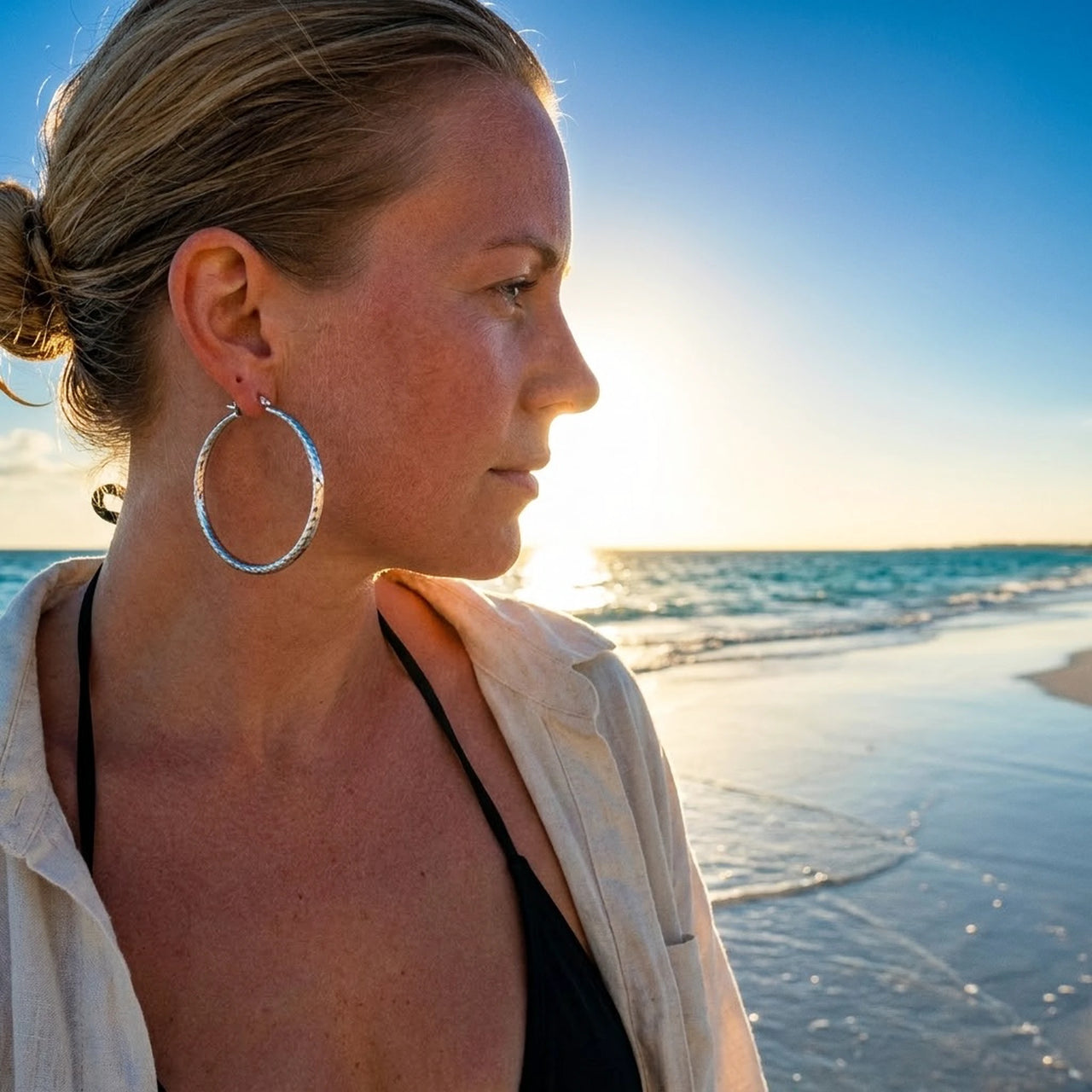 Diamond Cut Statement Hoops in Silver, worn on the beach | SKU: 41009-silver