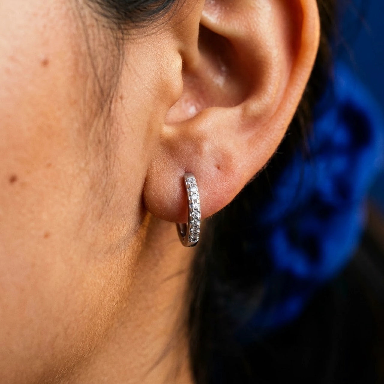 Pave Huggie Hoop Earrings in Silver, close-up on the earlobe | SKU: 41011-silver
