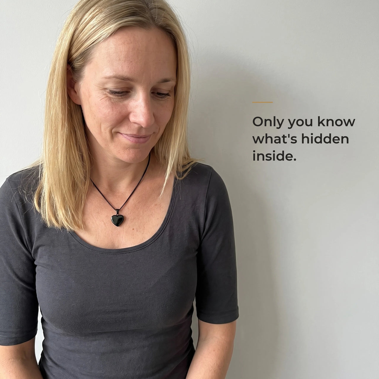 Woman wearing the black heart pendant, black on the outside, only she knows the photo inside | SKU: TPH-CHTN-BLACK-SMALL