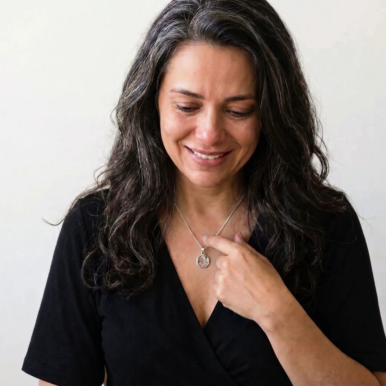 Woman moved as she looks at her late grandmother's photo in the silver octagon necklace | SKU: TPH-OCTN-SILVER