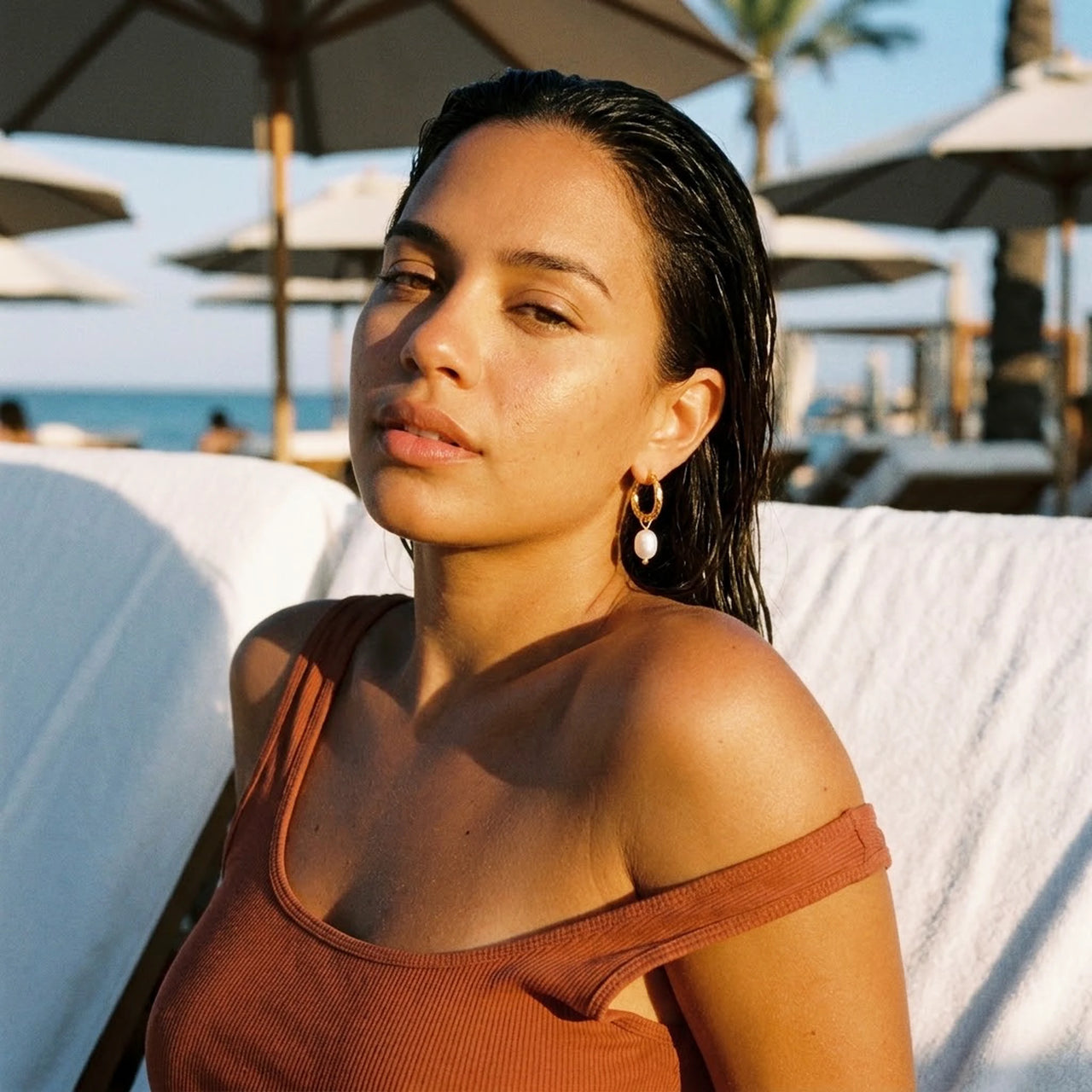 Twisted Pearl Drop Hoops in Gold, worn at a beach club at sunset | SKU: 41004-gold