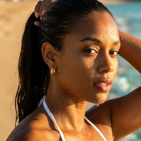Thumbnail for Twisted Rope Huggie Hoops in Gold, worn in the sea, wet skin | SKU: 41012-gold